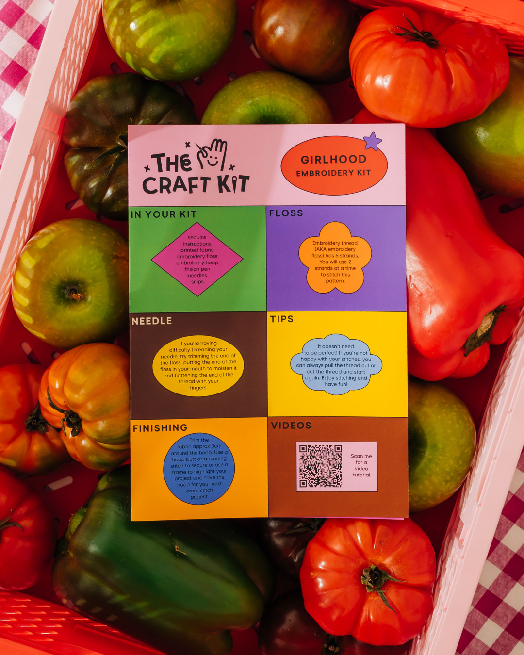 Colorful craft kit box with text on a background of tomatoes and peppers